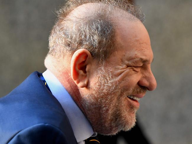 Harvey Weinstein manages to see the bright side of life as he arrives at court. Picture: AFP