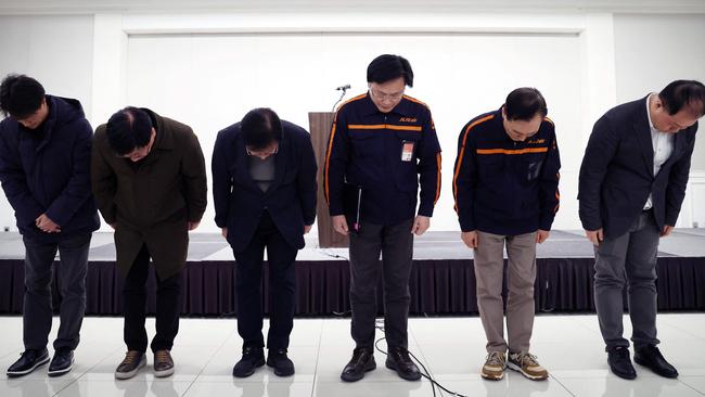 Jeju Air executive members bow in apology after a Jeju Air plane carrying 181 people from Thailand to South Korea crashed and burst into flames on arrival at Muan International Airport.Picture: Yonhap/AFP