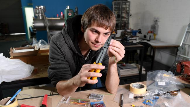 Neumann Space lab engineer Thomas Callum works on electronics for the prototype vacuum chambers for a space plasma thruster. Picture: AAP/Mark Brake