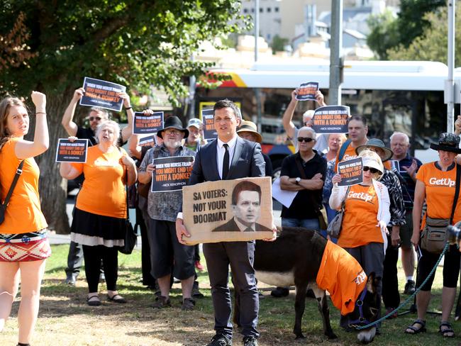 Members of GetUp! with two donkeys in Adelaide as the lobby group calls out then Senator Nick Xenophon’s support for business tax cuts. Picture: Kelly Barnes / The Australian