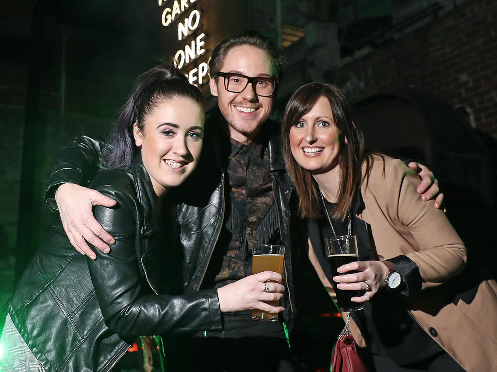 From left, Chloe Bennett, Jacob Perkins and Kellie Walker celebrae the start of Dark Mofo at In the Hanging Garden. Picture: LUKE BOWDEN