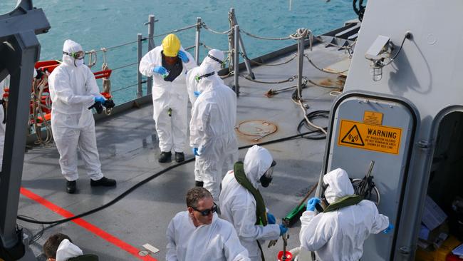 Royal Australian Navy sailors from HMAS Brisbane prepare to conduct search and rescue operations in the vicinity of Lindeman Island.