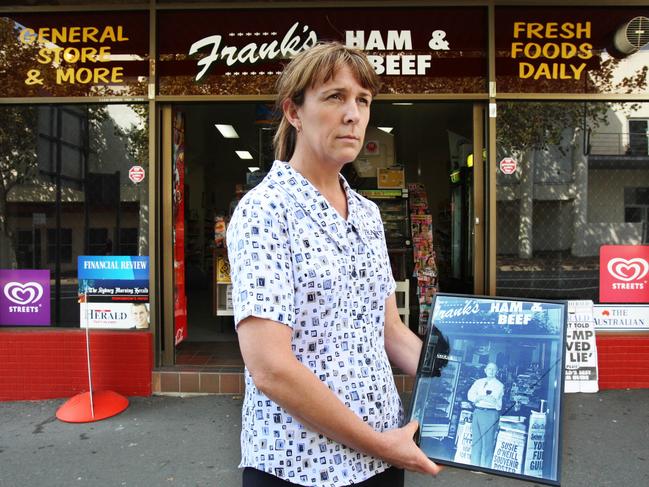 Employee Jenny Boswell of Frank's Ham and Beef, holding a picture of former owner Frank Newbery, who was murdered at the store almost one year ago after decades in business at the corner store in Union Street, Cooks Hill in Newcastle.