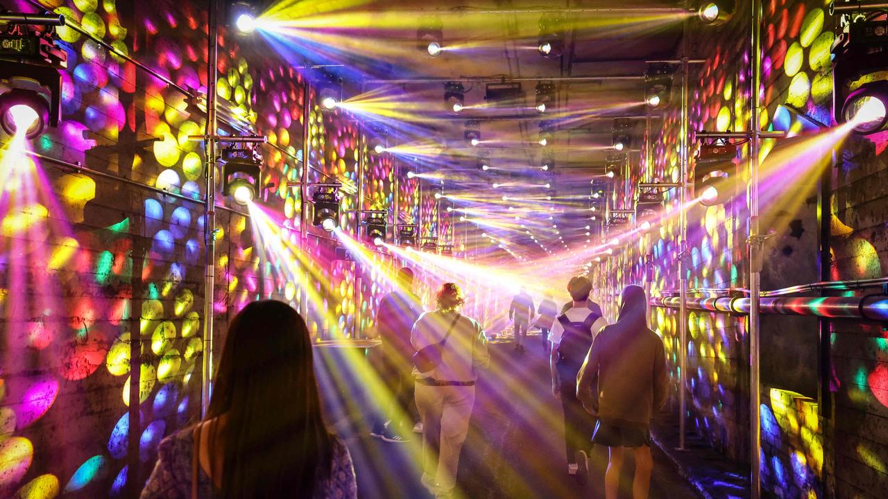 People view an installation of projections and lights called "Dark Spectrum" located at old tram tunnels as part of the annual Vivid Sydney Festival in Sydney. Picture: David Gray.