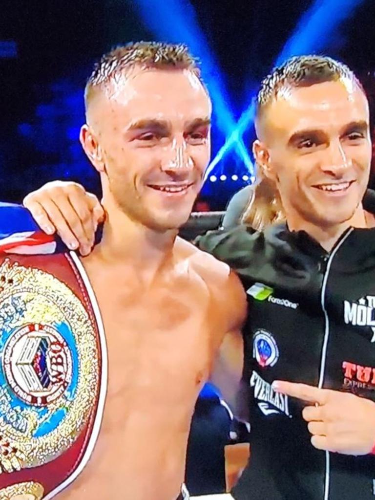 Jason Moloney with his brother and his title belt.