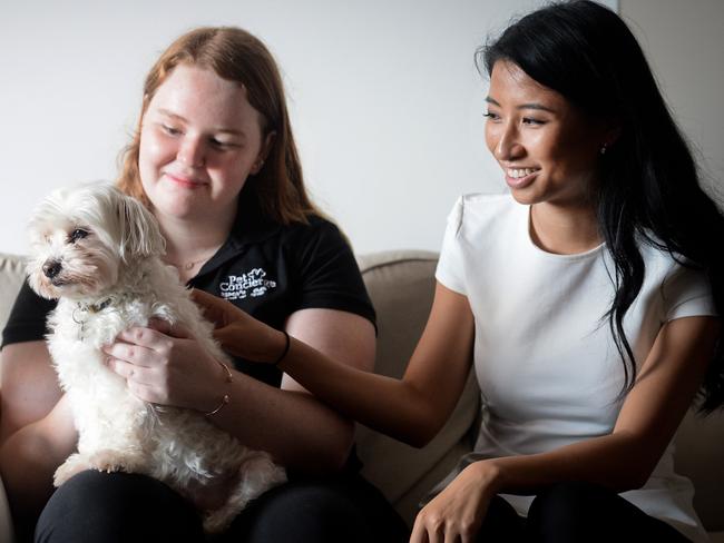 RSPCA vet nurse Scarlett Widdowson and Frances Zeng from Mirvac offer the pet concierge service to dogs like Romeo. Picture: Jeremy Piper