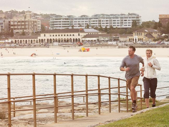 Mature Couple exercising at the beach. Bondi beach, Australia.