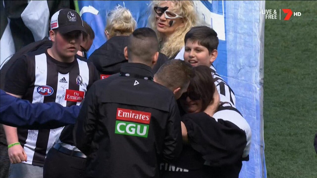 Nathan Buckley consoles a member of the Collingwood cheer squad.