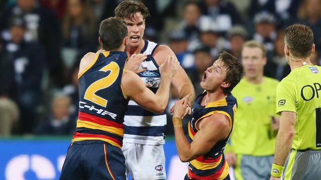 Matt Crouch goes down after copping a jumper punch from Tom Hawkins.