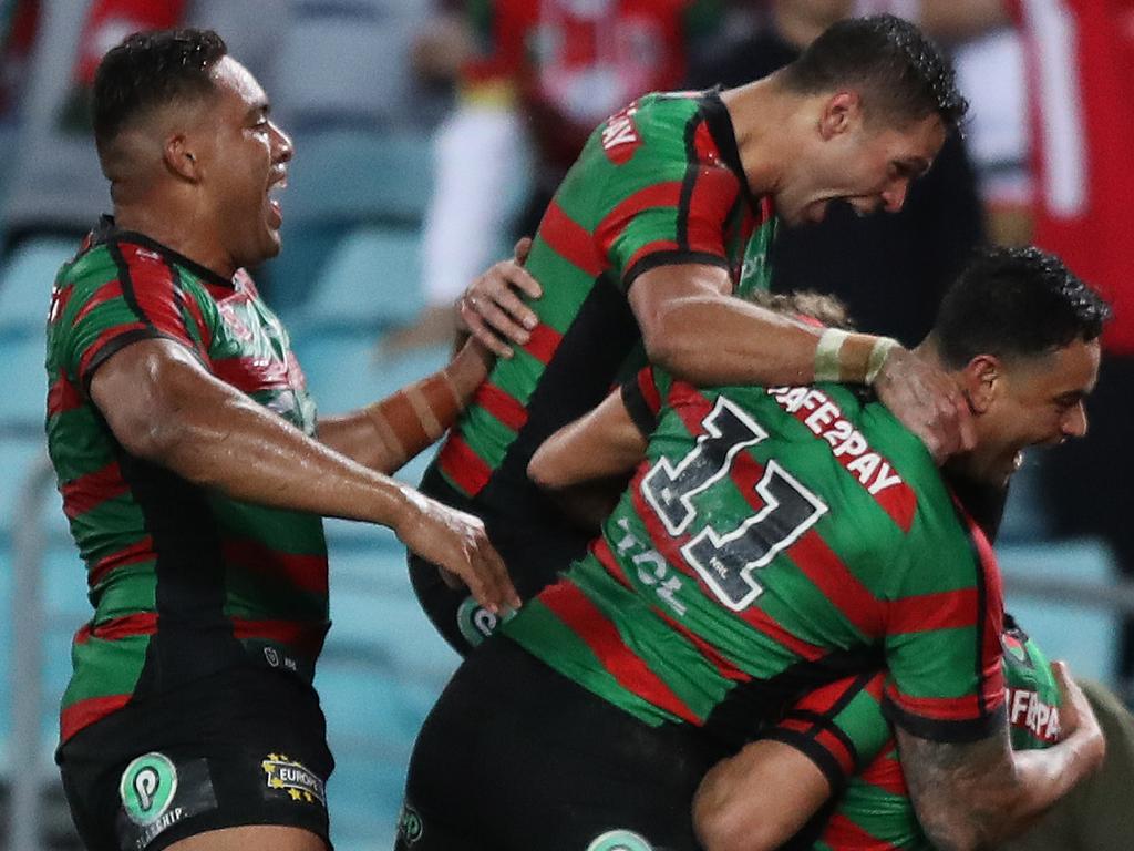 Souths players celebrate the winning try by Campbell Graham in the last seconds of the match during the South Sydney v St George NRL match at ANZ Stadium, Homebush. Picture: Brett Costello