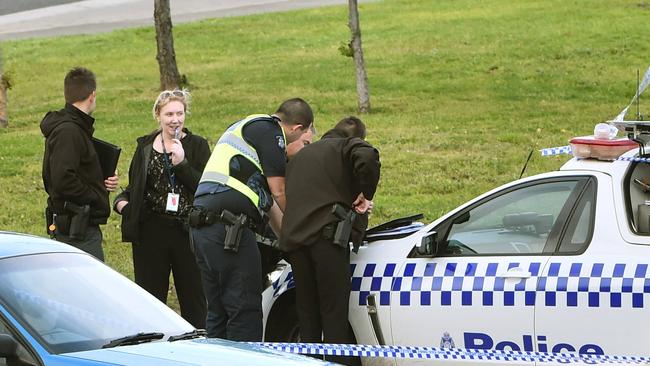 Investigators confer at the scene. Picture: Carmelo Bazzano