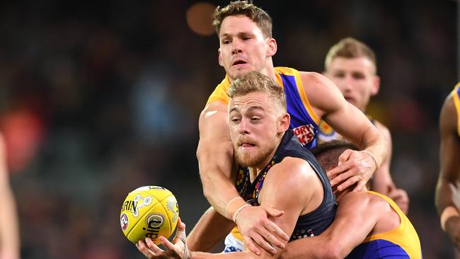 Hugh Greenwood of the Crows tackled by Elliot Yeo and Jack Redden. Picture: Mark Brake/Getty Images