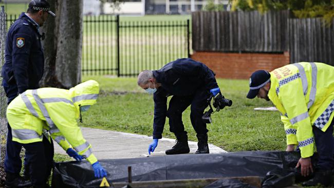 Police on the scene in the aftermath of the stabbing. Picture: Adam Yip