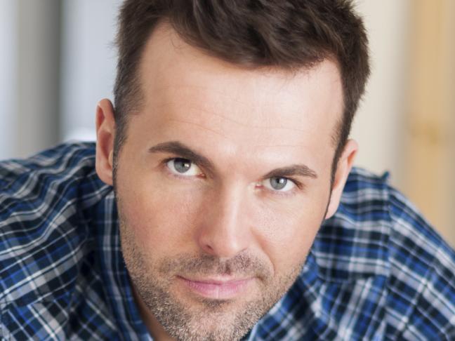 Portrait of handsome construction worker with home plans