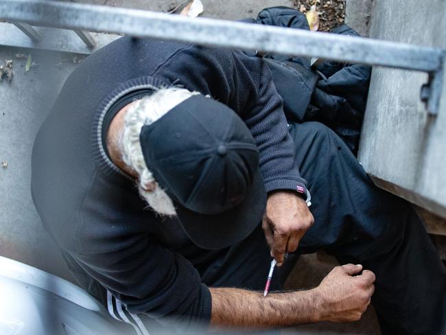 A man uses drugs in the carpark next to the Richmond injecting facility. Picture: Sarah Matray