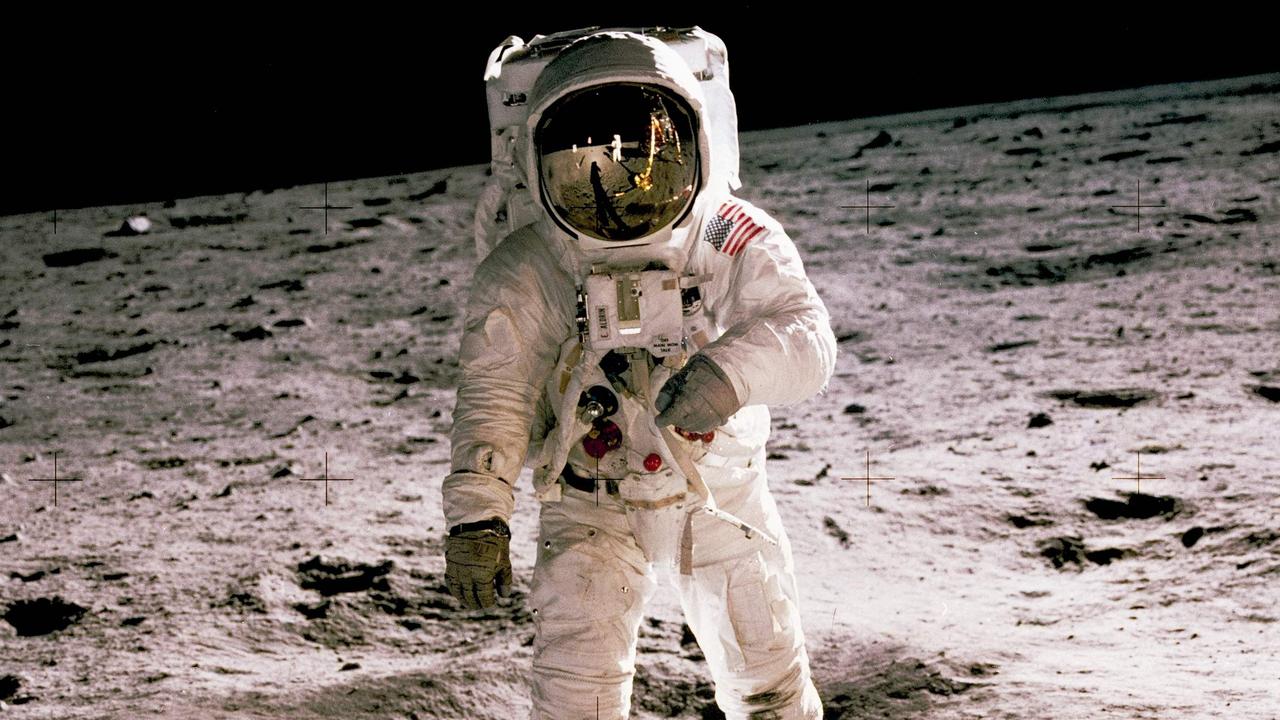 This photo aken by Neil Armstrong (reflected on helmet) shows Buzz Aldrin walking on the Moon on July 20, 1969. Picture: AFP/NASA