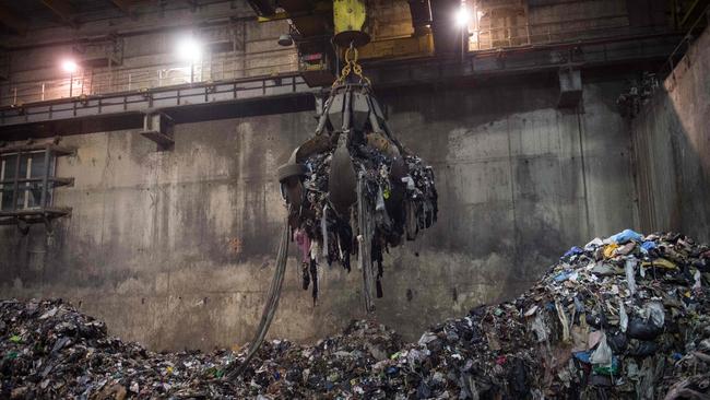 Handling machine collects household waste before it is burnt. (Photo by CLEMENT MAHOUDEAU / AFP)