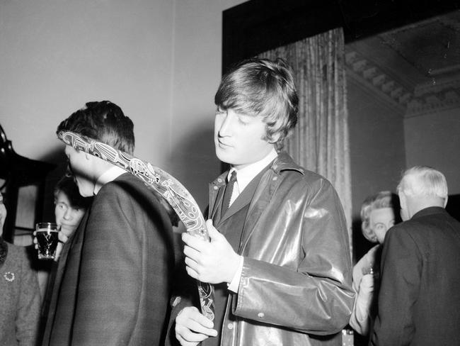 John Lennon examines a boomerang at the state reception at the Melbourne Town Hall. Picture: Herald Sun Image Library