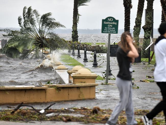 People walk on the Sanford river walk along Lake Monroe. Picture: Getty Images/AFP