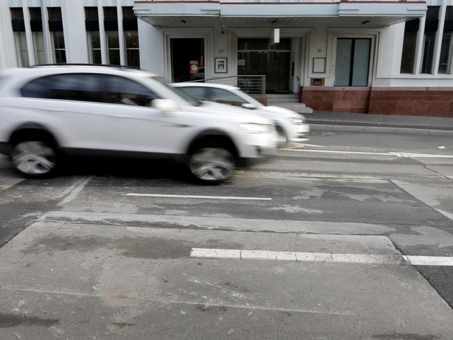 Busy Hobart traffic travels down Macquarie St, over a patch of road under which Australian performance artist Mike Parr will be buried alive. Picture: Patrick Gee