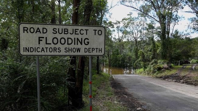 A warning sign as floodwater submerges the road at Cattai Ridge Road. Picture: NCA NewsWire/Bianca De Marchi