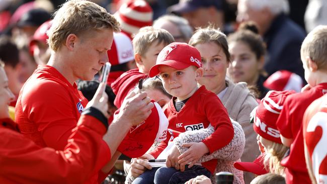 Isaac Heeney signs autographs for Swans fans. Picture: Phil Hillyard