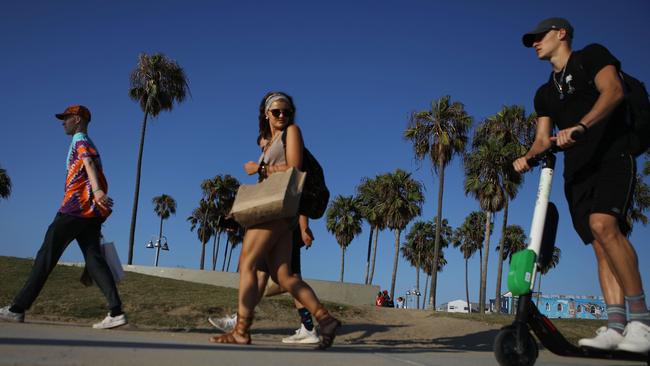 The Lime scooters are used in many American cities. Pictured is a user along Venice Beach. Pic Mario Tama/Getty Images