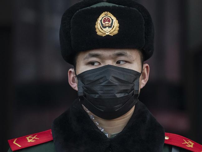 BEIJING, CHINA - JANUARY 22: A Chinese police officer wears a protective mask as he stands guard at Beijing Station before the annual Spring Festival on January 22, 2020 in Beijing, China. The number of cases of a deadly new coronavirus rose to over 400 in mainland China Wednesday as health officials stepped up efforts to contain the spread of the pneumonia-like disease which medicals experts confirmed can be passed from human to human. The number of those who have died from the virus in China climbed to nine on Wednesday and cases have been reported in other countries including the United States,Thailand, Japan, Taiwan and South Korea. (Photo by Kevin Frayer/Getty Images) *** BESTPIX ***