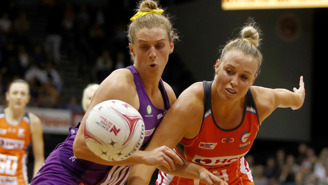 Gabi Simpson of the Firebirds (left) and Kimberlee Green of the Giants fight for the ball during the Round 4 Super Netball match between the Giants Netball and the Queensland Firebirds at Quaycentre in Sydney, Saturday, May 19, 2018. (AAP Image/Daniel Munoz) NO ARCHIVING, EDITORIAL USE ONLY