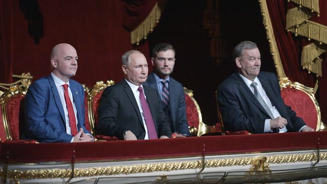 Vladimir Putin, centre, with FIFA President Gianni Infantino, left, and Bolshoi Theatre director Vladimir Urin at a concert to mark the closing of the World Cup at the Bolshoi in Moscow on Saturday. Picture: AP