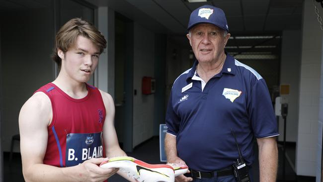 Billy Blair from St Josephs showing an official his shoes after the record.