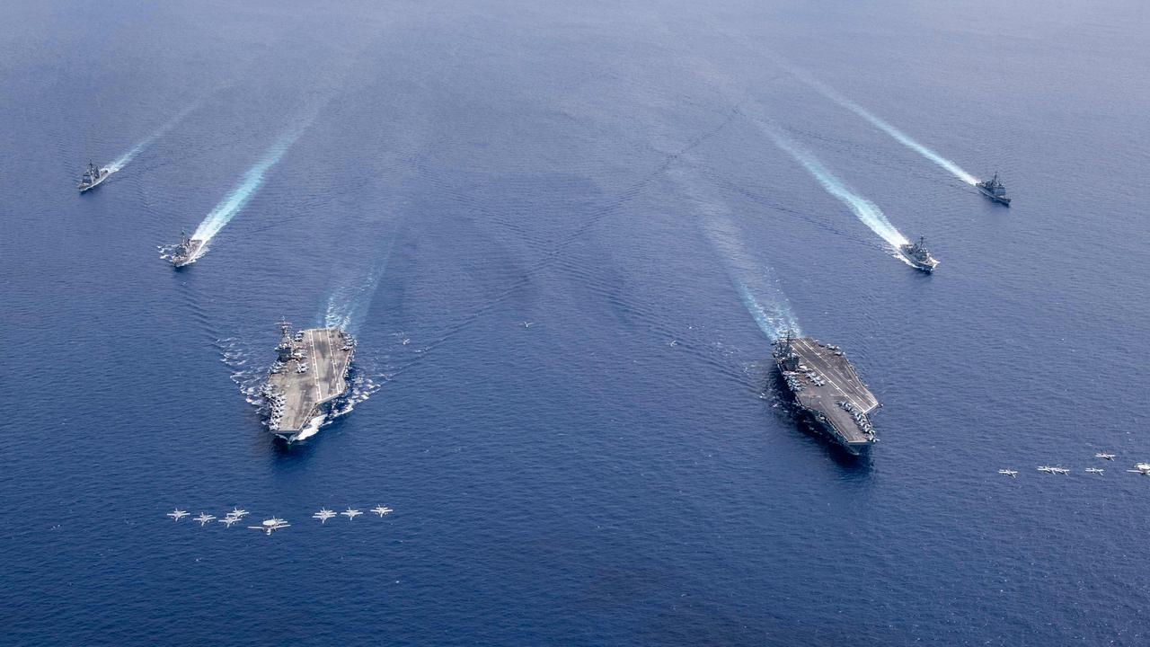 US aircraft from Carrier Air Wings (CVW) 5 and 17 as they fly in formation over the Nimitz Carrier Strike Force, the aircraft carriers USS Nimitz (CVN 68)(R), and USS Ronald Reagan (CVN 76) as their carrier strike groups are conducting dual carrier operations in the Indo-Pacific.