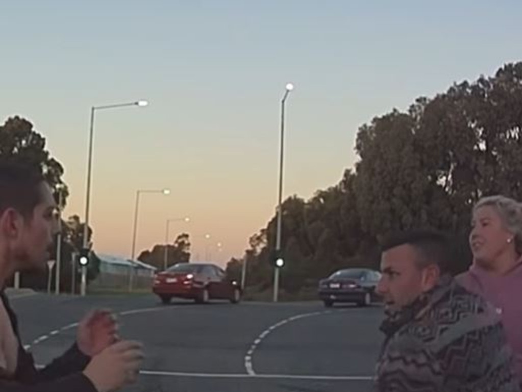 A wild roadside brawl in Melbourne has been captured on a dashcam, with what appears to be two couples throwing fists at an intersection.