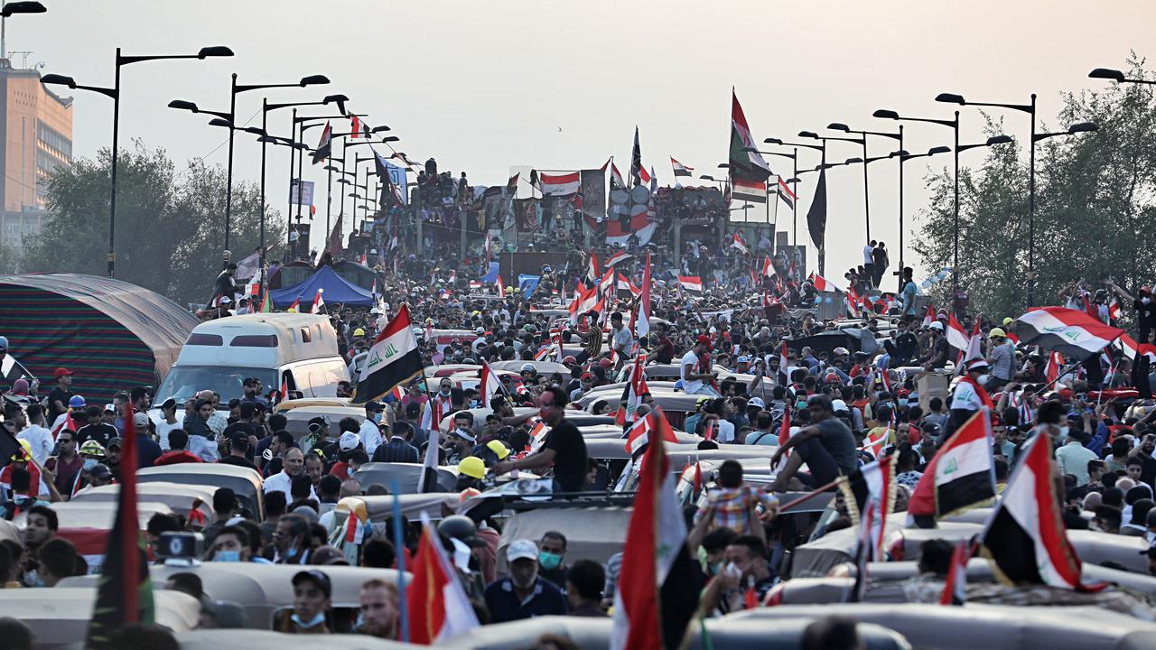 Anti-government protesters gather on the Joumhouriya closed bridge leading to the Green Zone government areas during ongoing protests in Baghdad.