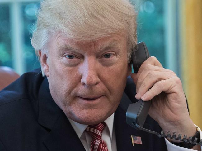 US President Donald Trump waits to speak on the phone with Irish Prime Minister Leo Varadkar to congratulate him on his recent election victory in the Oval Office at the White House in Washington, DC, on June 27, 2017. / AFP PHOTO / NICHOLAS KAMM