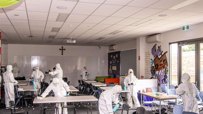 Cleaners photographed cleaning a classroom. (AAP Image / Monique Harmer)