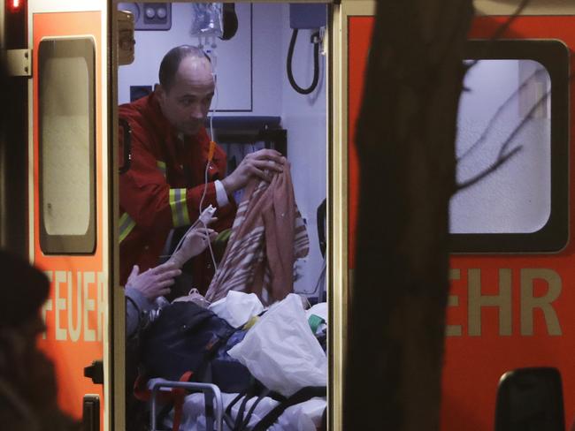 A firefighter attends a person injured during the Berlin Christmas market attack. Picture: AP