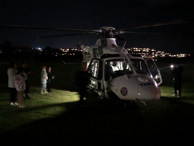 A medical team from the NSW Ambulance emergency helicopter, which landed at James Meehan Reserve, Dee Why, helped treat the critically injured man before he was taken by road to Royal North Shore Hospital. Picture: Jim O’Rourke