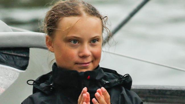 Swedish climate activist Greta Thunberg, 16, and father Sventa Thunberg arrive in the US after a 15-day journey crossing the Atlantic in the Malizia II, a zero-carbon yacht, on August 28, 2019 in New York. - "Land!! The lights of Long Island and New York City ahead," she tweeted early Wednesday. She later wrote on Twitter that her yacht had anchored off the entertainment district of Coney Island in Brooklyn to clear customs and immigration. (Photo by Kena Betancur / AFP)