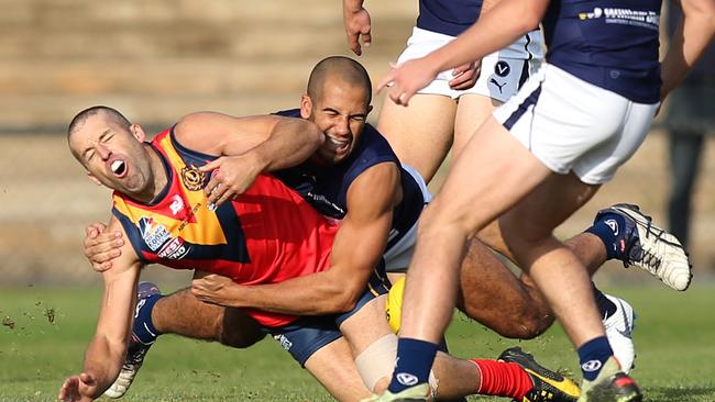 SA's Justin Sheedy is tackled heavily by Victoria's Courtney Hylton during the representative match between the Adelaide Footy League and Victorian Amateur Football League last year. Picture: AAP Image/Dean Martin