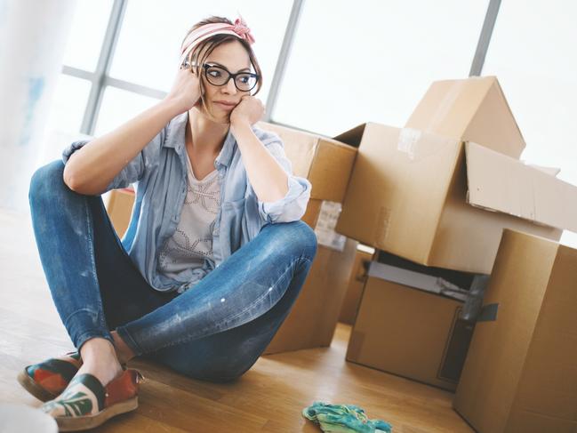 Young woman sitting on the floor, tired of all the work that she done by herself at her apartment. Eviction. Tenant. Renter. Renting. Evicted. Source: iStock - for Herald Sun realestate