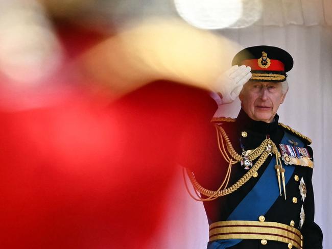 King Charles III salutes The Irish Guards marching in front of him at the end of a ceremony where he presents New Colours to No 9 and No 12 Company. Picture: AFP