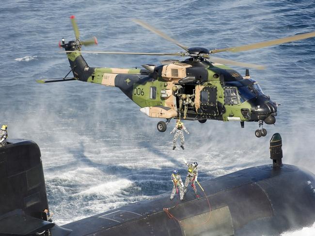 An Australian Submarine conducts personnel transfers with a MRH-90 Taipan helicopter. Picture: Royal Australian Navy.