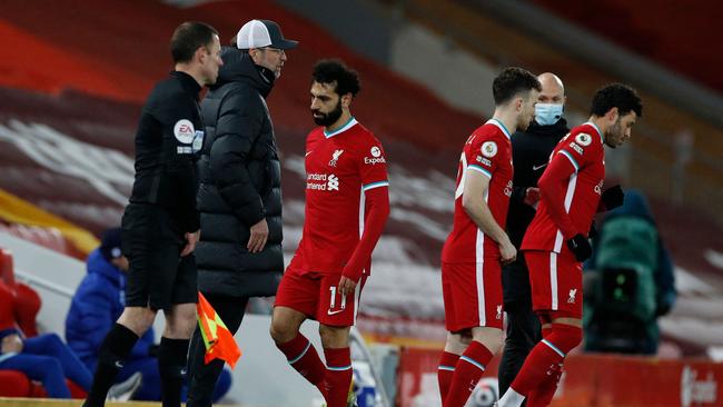 Liverpool's Egyptian midfielder Mohamed Salah (C) leaves the pitch after being substituted during the English Premier League football match between Liverpool and Chelsea at Anfield in Liverpool, north west England on March 4, 2021. (Photo by PHIL NOBLE / POOL / AFP) / RESTRICTED TO EDITORIAL USE. No use with unauthorized audio, video, data, fixture lists, club/league logos or 'live' services. Online in-match use limited to 120 images. An additional 40 images may be used in extra time. No video emulation. Social media in-match use limited to 120 images. An additional 40 images may be used in extra time. No use in betting publications, games or single club/league/player publications. /