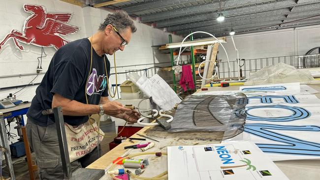 Michael Blazek, a glass bender, is one of the collectors showcasing a number of his Queensland neon signs. Picture: State Library of Queensland.