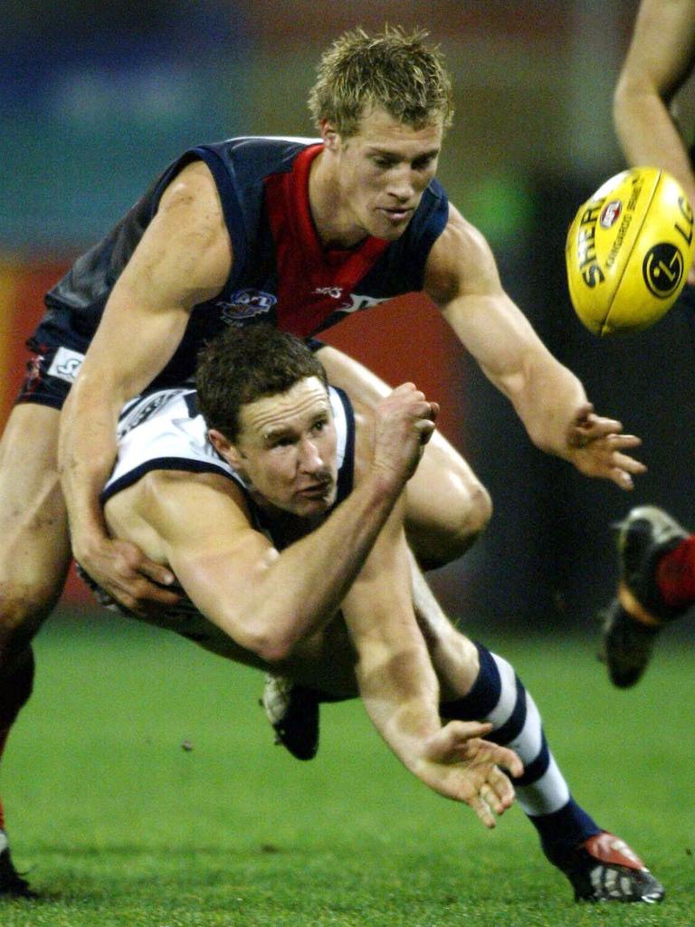 2003 - Geelong’s Ben Graham handballs away under pressure from Melbourne’s Scott Thompson.