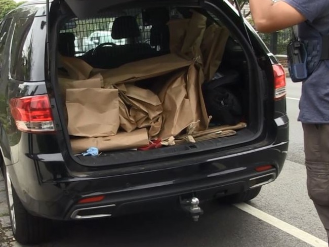 A police car loaded with guns and drugs seized in the raid.