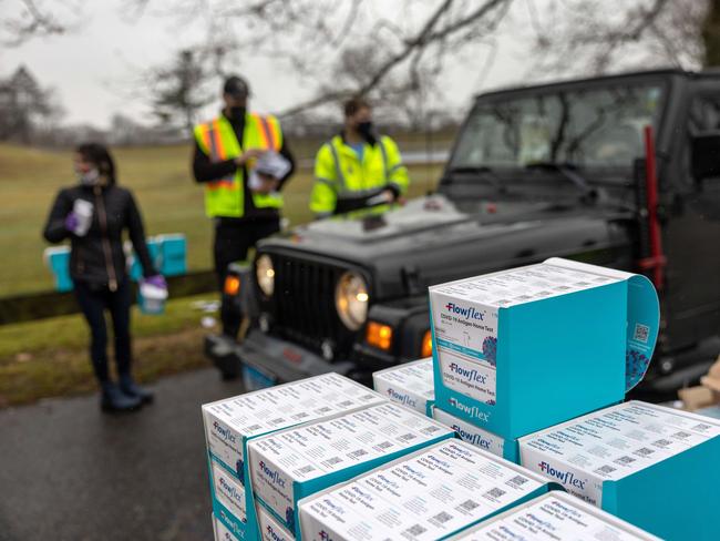 US residents of Connecticut receive free at-home Covid-19 test kits at a distribution site as the US hits one million virus cases per day. Picture: AFP