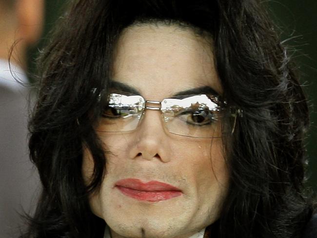 (FILES) In this file photo taken on June 03, 2005, Michael Jackson waves as he arrives at the Santa Barbara County courthouse in Santa Maria, California. - An unflinching new documentary on pedophilia accusations against Michael Jackson shatters the veneer of his larger-than-life celebrity, presenting in stark, lurid detail the stories of two men who say the late King of Pop for years sexually abused them as minors. (Photo by Timothy A. CLARY / AFP)