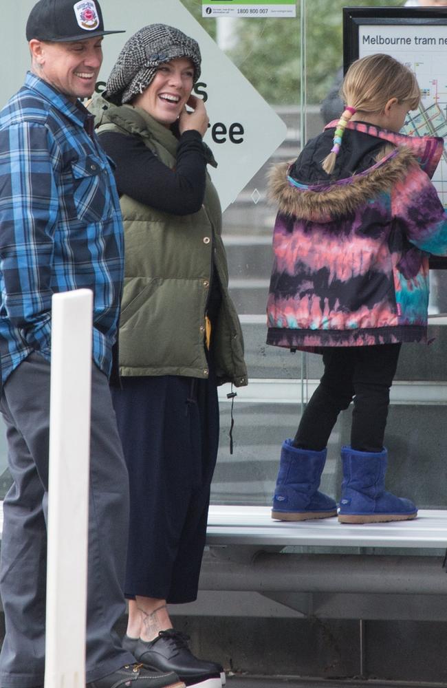 Pink and her husband, Carey Hart, with their daughter Willow wait for a tram. Picture: Media Mode